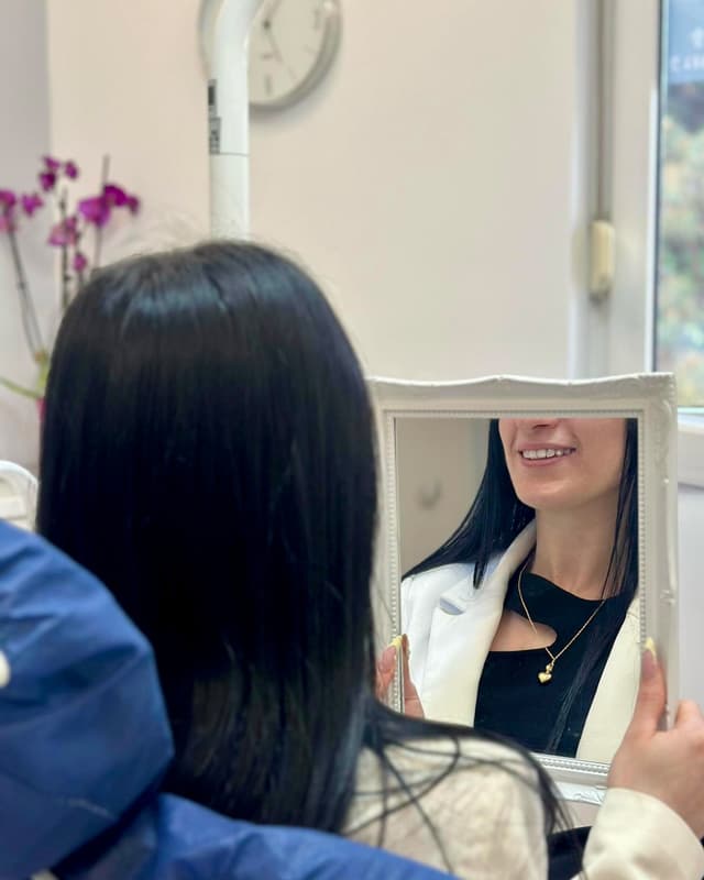 Patient admiring her smile transformation